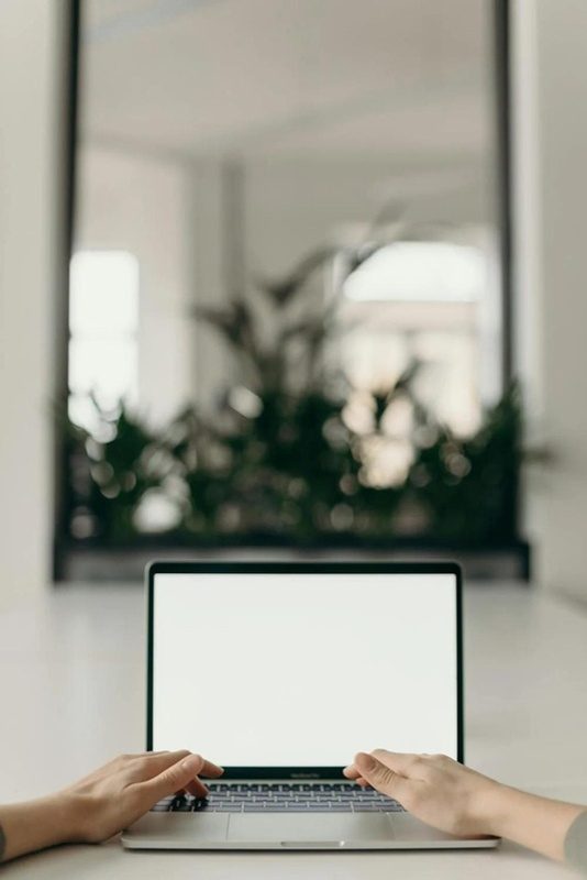 A workspace with a laptop displaying the DonDon & Co. mark