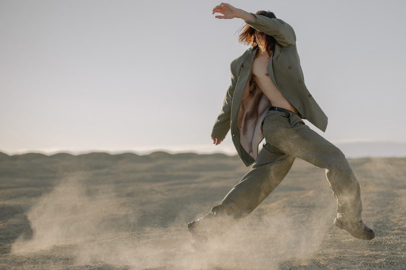 A figure walking across a desert landscape, representing brand journeys